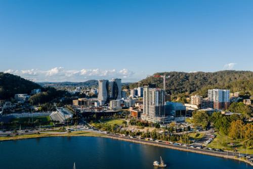 an aerial view of a city with a body of water at voco Gosford by IHG in Gosford