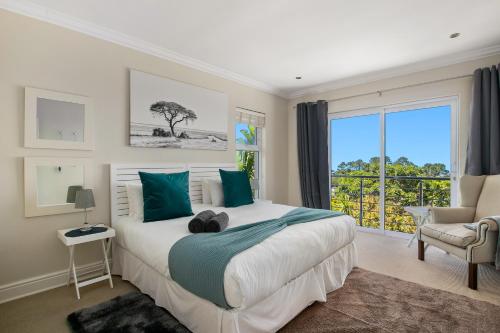 a bedroom with a large bed and a window at SL9 - Pezula Double Storey Luxury in Knysna