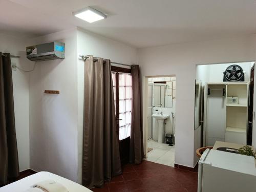 a room with a bathroom with a shower curtain at My Place Boutique Hotel in Puerto Iguazú