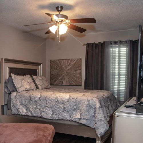 a bedroom with a bed and a ceiling fan at Cozy 2 Bedroom Townhome in Addison in Addison
