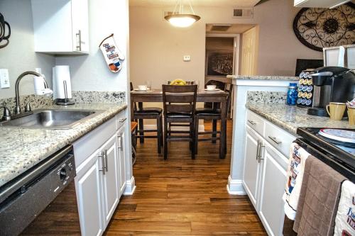 a kitchen with a sink and a counter top at Cozy 2 Bedroom Townhome in Addison in Addison