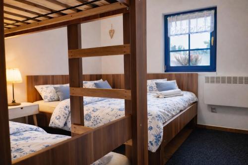 two bunk beds in a room with a window at Piemonti Bešeňová in Bešeňová