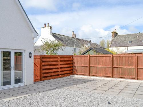 a wooden fence in front of a house at Crofthouse - Uk43405 in Wigtown