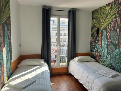 two beds in a room with a window at Oops! Latin quarter by Hiphophostels in Paris