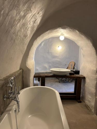 a bathroom with a bath tub and a sink at L'Hostal de Piaghja in Calenzana
