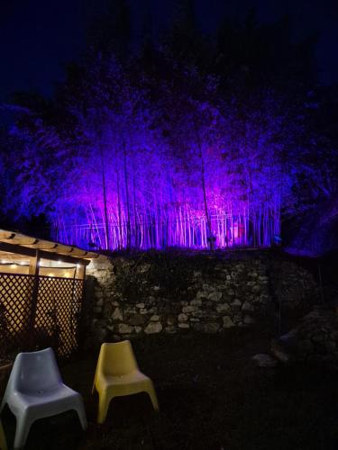 two chairs in front of a wall with purple lights at Vacation Home Tuscany Pisa-Lucca 1 in Filettole