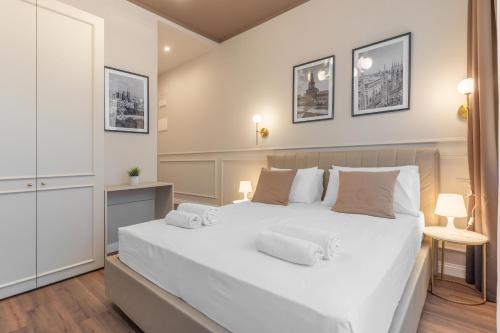 a bedroom with a large white bed with two pillows at Welcome Foresteria Lombarda in Milan