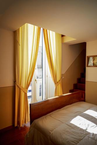 a bedroom with a bed and a large window at GOLA Dimora storica in Cerignola