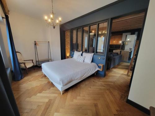a bedroom with a large bed in a room at Le Loft Des Arts in Thonon-les-Bains