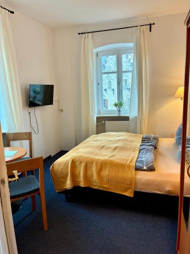 a hotel room with a bed and a window at Restaurant Rebea in Sulzburg
