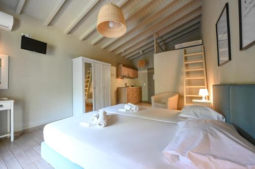 a bedroom with a large white bed in a room at Aggelos Grand in Koukounaries