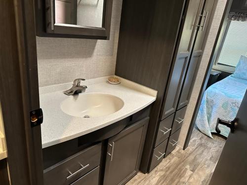 a bathroom with a sink and a mirror at Big Pine Key RV Park in Big Pine Key