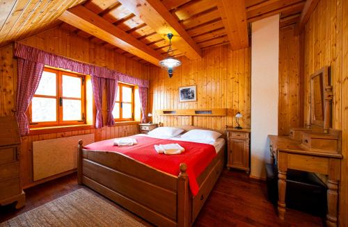 a bedroom with a bed in a wooden room at Pinius by Hotel Pieris in Pribylina