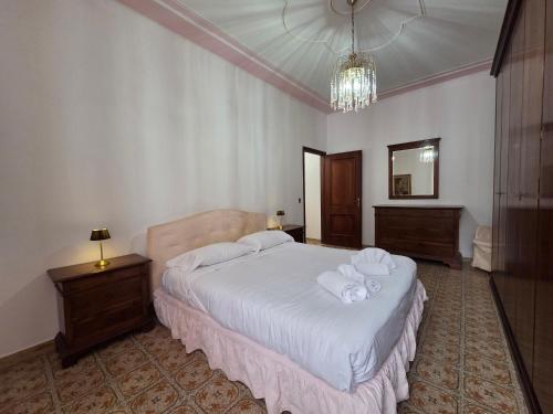 a bedroom with a bed with white sheets and towels at Poesia - By Ligooria in Pietra Ligure