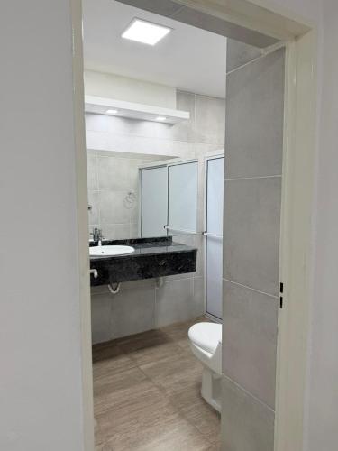 a bathroom with a sink and a toilet and a mirror at Seven Hotel - Juana Koslay San Luis in Juana Koslay 