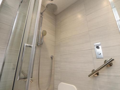 a shower in a bathroom with a glass shower stall at Wardenlea in Preston