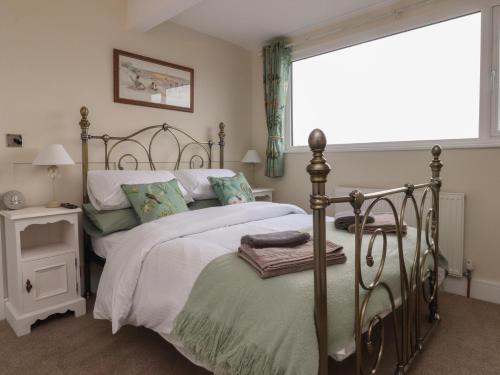 a bedroom with a large bed and a window at Wardenlea in Preston