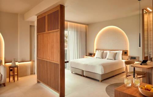 a hotel room with a bed and a desk at Zeus Kos Beach in Mastihari