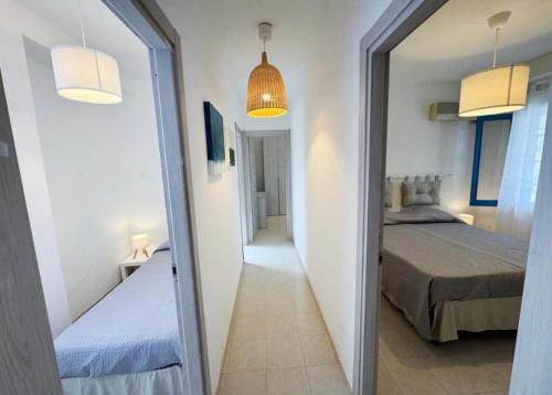 a mirror in a room with a bed and a bedroom at Villa Marzamemi in Marzamemi