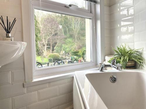 a bathroom with a sink and a window at Bronafon in Rhyl