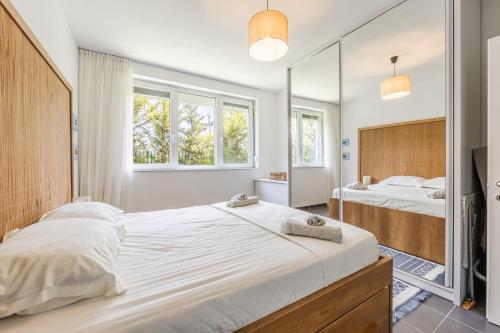 a bedroom with a large bed and a mirror at Talea Joyful Stay by PikHost in Lezhë