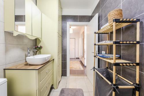 a bathroom with a sink and a mirror at Talea Joyful Stay by PikHost in Lezhë
