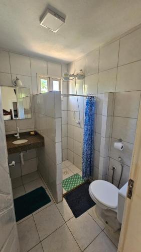 a bathroom with a shower and a toilet and a sink at Vila dos Ventos - EcoPousada in Estância