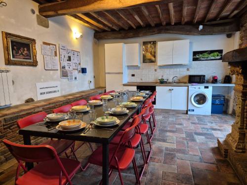 a long table with red chairs in a kitchen at Vacation Home Tuscany Pisa-Lucca 2 in Filettole