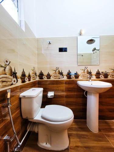 a bathroom with a toilet and a sink at Cloud View Family Villa in Kandy