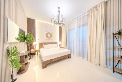 a bedroom with a bed and a chandelier at 3BR Amazing Villa - Private Pool - 3WC - BBQ Pit in Sharjah