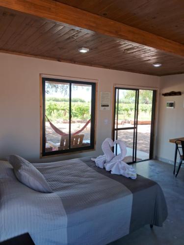 a bedroom with a bed with a towel on it at Viñedos de la Luna in Fiambalá