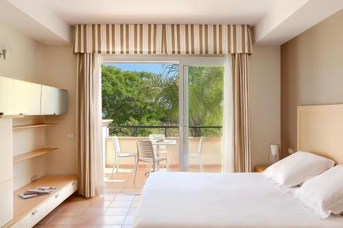 a bedroom with a bed and a view of a patio at Elviria Hills Living in Marbella