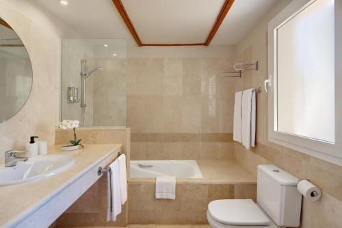 a bathroom with a sink and a toilet and a tub at Elviria Hills Living in Marbella