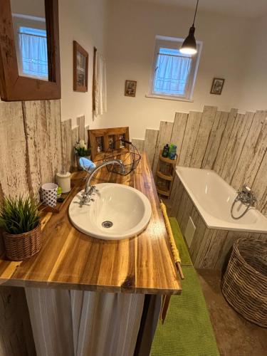 a bathroom with a sink and a tub at Sziget Gyöngye Vendégház in Tahitótfalu