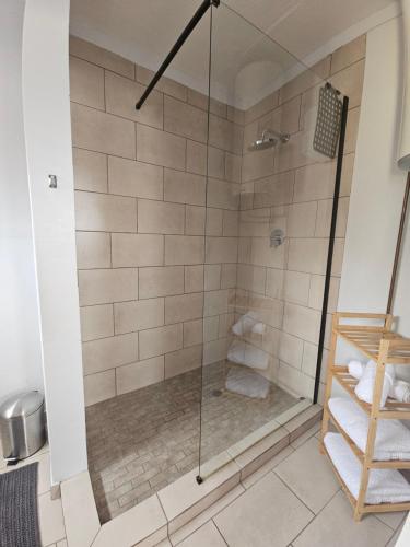 a shower with a glass door in a bathroom at 22 On Schwester Frieda in Swakopmund