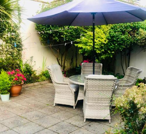 a table and chairs with an umbrella on a patio at Seashore Lodge Guesthouse in Galway
