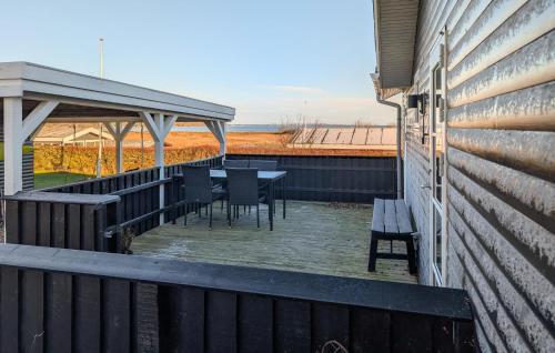 a deck with a table and chairs on a house at 3 Bedroom Cozy Home In Haderslev in Haderslev