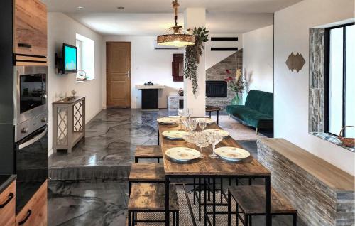 a kitchen and living room with a table and chairs at Bel Appartement Reposant in Rambervillers