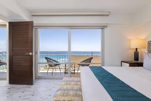 a bedroom with a bed and a view of the ocean at #Marbella Lane - Luxe 2BR with Panoramic Ocean View in Honolulu