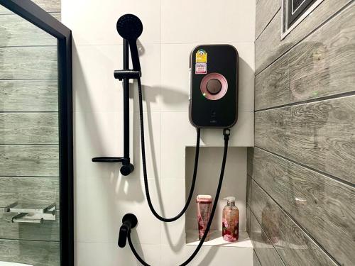 a shower with a camera on the wall of a bathroom at Angie Tiny House near Krabi Airport with Free Airport Shuttle