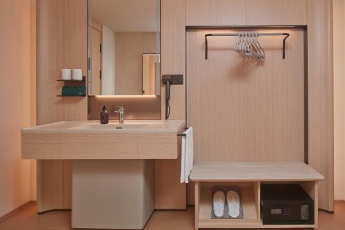 a bathroom with a sink and a mirror at JI Hotel Vientiane Mekong Riverside in Vientiane