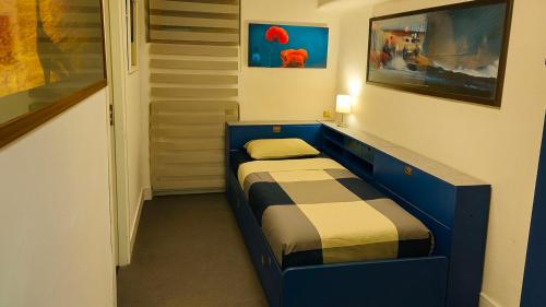a small bedroom with a blue bed in a room at La Piccola Rocca in Cetona