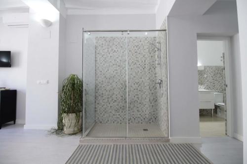 a shower with a glass door in a room at Jome Stays La Nucía in La Nucía