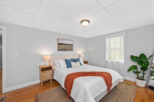 a white bedroom with a bed and a window at Boston Condo With FREE Parking in Boston