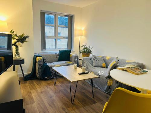 a living room with a couch and a table at Endsleigh Park Hotel in Hull