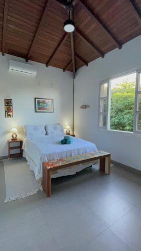 a bedroom with a large bed and a large window at Casa Boomerang in Marau