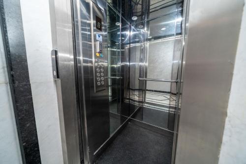 a stainless steel elevator in a building with its door open at Luxury Abraj YK 120m2 in Tangier