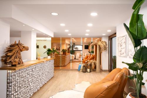 a living room with a couch and a table at Hotel Bellariva in Lido di Jesolo