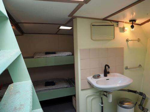a bathroom with a sink and two bunk beds at FLOW in Amsterdam