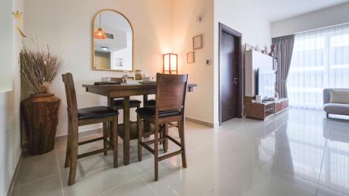 a dining room with a table and chairs and a mirror at Azure Marina 1BR - Elegant Chic Haven in Abu Dhabi